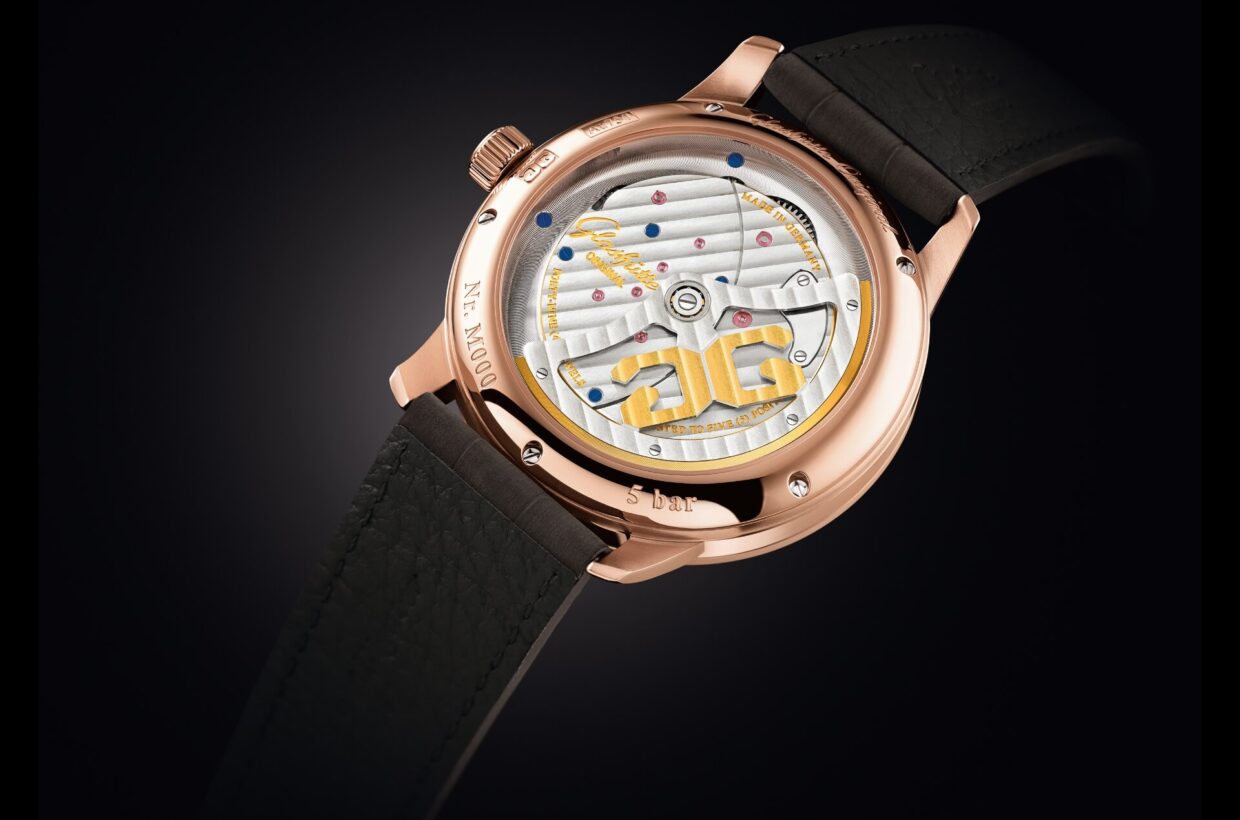 Traditionally finished movement Traditionally finished manufactory movement, Glashütte stripes finish on three-quarter plate, visible perlage on base plate, screw-mounted gold chatons and classic ruby bearings, hand-engraved butterfly bridge 